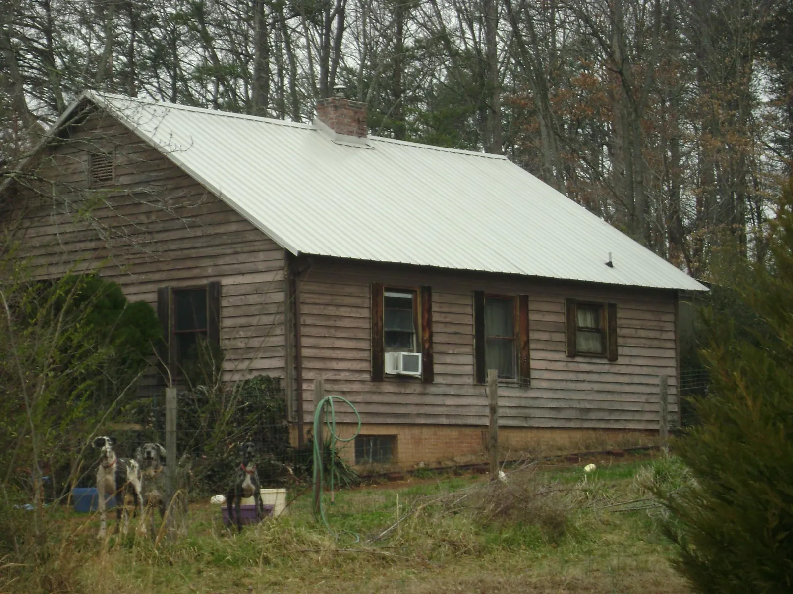 White metal roof on an old wood sided farmhouse, from a Metal Roof Installation job in Cottonwood